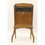 Liberty style arts & crafts oak side cabinet, the single leaded glass and panelled door enclosing