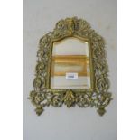 Victorian cast brass small hanging wall mirror with mask head surmount, 15ins x 9.5ins