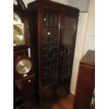 Mid 20th Century oak display cabinet having two leaded glazed doors with adjustable shelves above