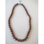 Single row chocolate cultured pearl necklace with a 9ct yellow and white gold ball form clasp 45cm