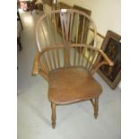 Early 20th Century oak and elm Windsor armchair with stick and splat back, raised on turned supports