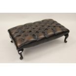 20th Century brown leather button upholstered large footstool on cabriole supports with pad feet,