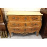 20th Century Continental Kingwood bombe commode, the veined beige marble top above three drawers