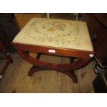 Mahogany dressing table stool with needlepoint drop-in seat on crossover supports, 19.5ins wide