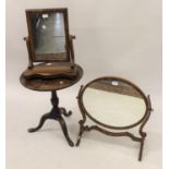 Two mahogany swing frame toilet mirrors together with a small mahogany tripod table (reduced in