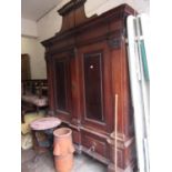 19th Century Continental walnut armoire, the heavy moulded and dentil cornice with a shaped surmount