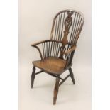 Large 19th Century yew and elm Windsor chair, the high hoop, stick and splat back above a carved