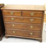 George III oak chest of two short and three long drawers with brass handles and escutcheons, flanked