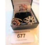 Group of three 9ct yellow gold dress rings of flower head designs set semi precious stones,