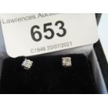 Pair of white gold diamond solitaire claw set stud earrings