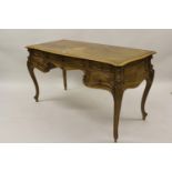 Late 19th / early 20th Century French walnut writing table, the crossbanded and moulded top above