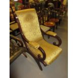 Victorian mahogany and upholstered elbow chair with scroll arms, raised on splay supports