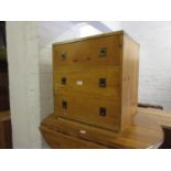 Stained pine three drawer bedside chest with brass inset military style handles