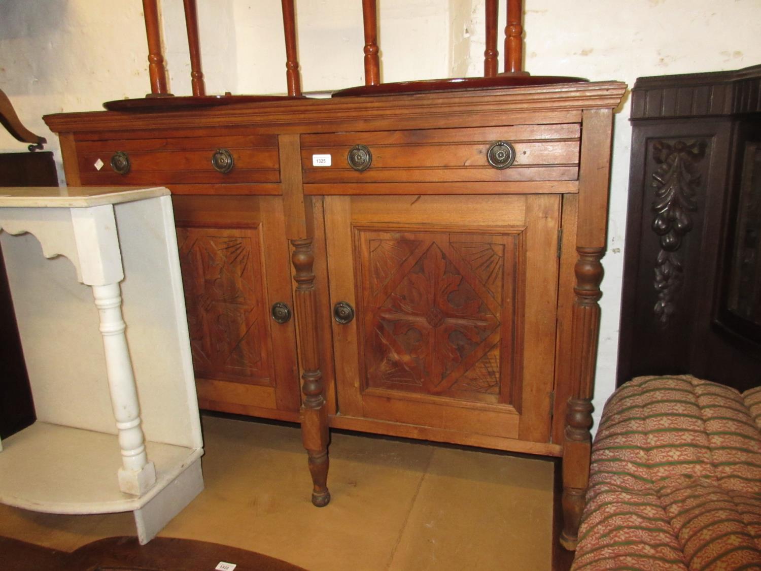 19th century Continental walnut side cabinet with two drawers above two carved panel doors on turned