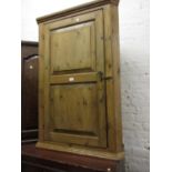 19th Century polished pine hanging corner cabinet, the panel door enclosing shaped shelves