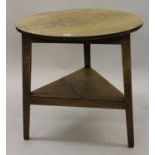 George III oak cricket table, the circular top raised on tapered supports with undertier, 30ins