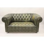 Pair of 20th Century green leather button upholstered two seat Chesterfield sofas, raised on low bun