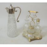 Silver plated four bottle condiment set together with a silver plated and glass claret jug