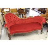 Good quality Victorian carved mahogany chaise longue, the shaped frame with deep buttoned red velvet