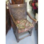 Antique oak Wainscot chair, the carved panel back and shaped arms above a plank seat, square cut