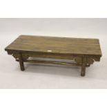 Eastern low stained pine opium table having ornate frieze and turned supports with stretchers, 12ins