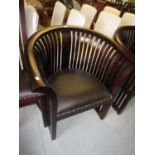 Pair of modern mahogany tub shaped chairs with slatted shaped backs and brown leather upholstered