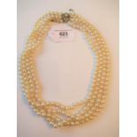 Four strand cultured pearl choker with a diamond and pearl set white and yellow metal clasp of Art
