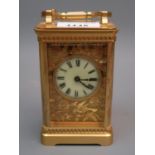 Early 20th Century gilt brass cased carriage clock, the enamel and gilt fretwork dial with Roman