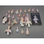 Collection of approximately twenty porcelain doll half figures, including an unusual larger figure