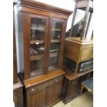 Edwardian walnut bookcase, the moulded cornice above a pair of glazed doors enclosing shelves, the