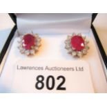 Pair of 9ct oval ruby and diamond cluster stud earrings Overall size of the cluster is about 15 x