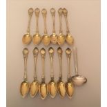 Set of twelve Continental silver teaspoons, together with a similar feeding spoon, 9oz Some light