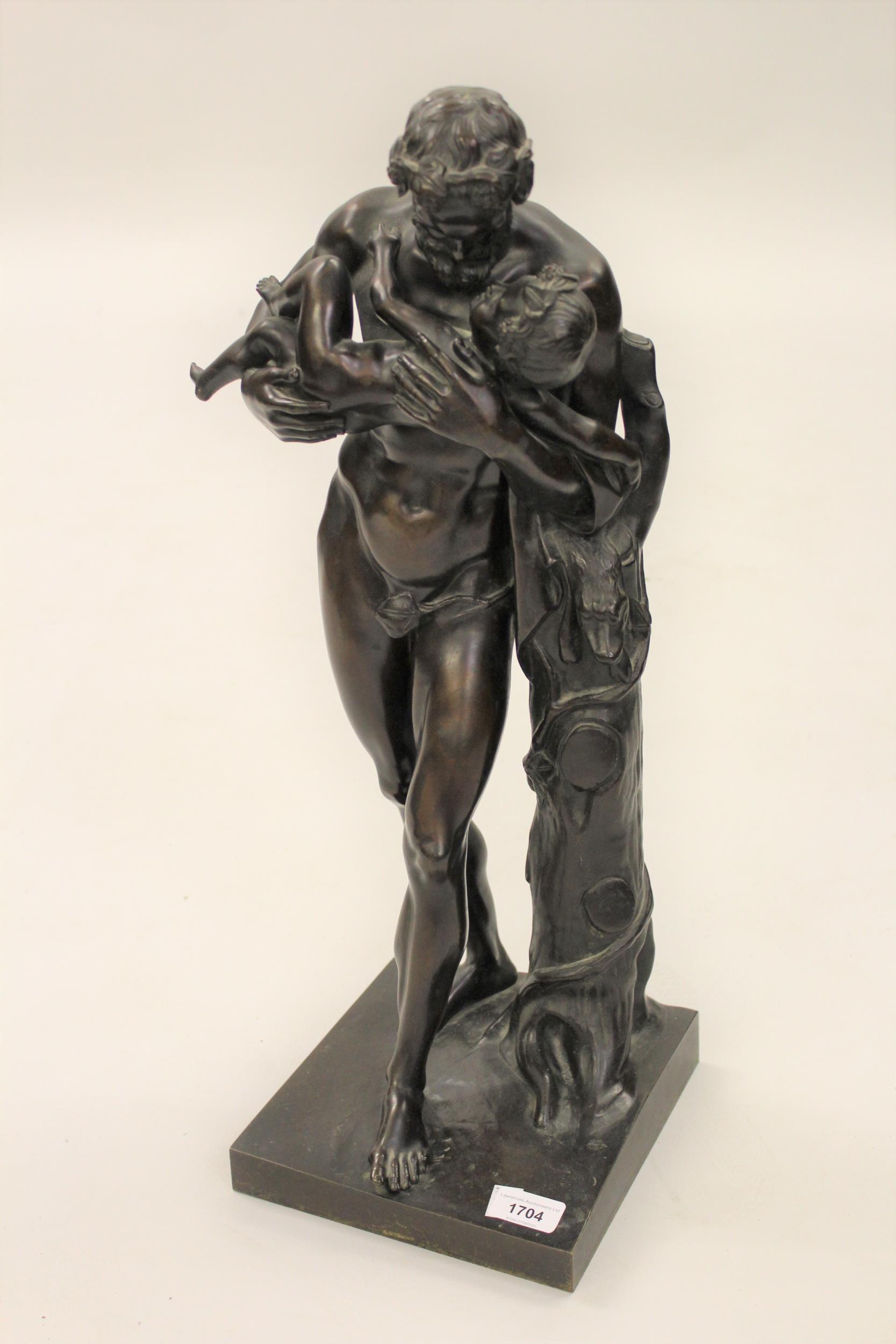 19th Century dark patinated bronze figure of a faun carrying a child beside a tree stump, on an