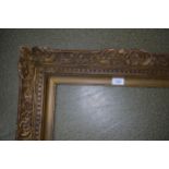 Early 20th Century giltwood picture frame, having carved 'C' scroll and dentil decoration, 22ins x