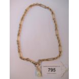 9ct Gold elongated link Albert watch chain with attached porcelain fob in the form of a clasped hand