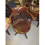 Early 20th Century mahogany revolving tub shaped office chair, with a moulded seat