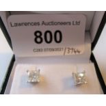 Pair of 14ct white gold Princess cut diamond stud earrings with screw backs, the diamonds