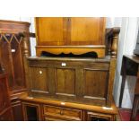 Mid 20th Century oak hall bench / table having hinged seat, turned supports and three panel base (at