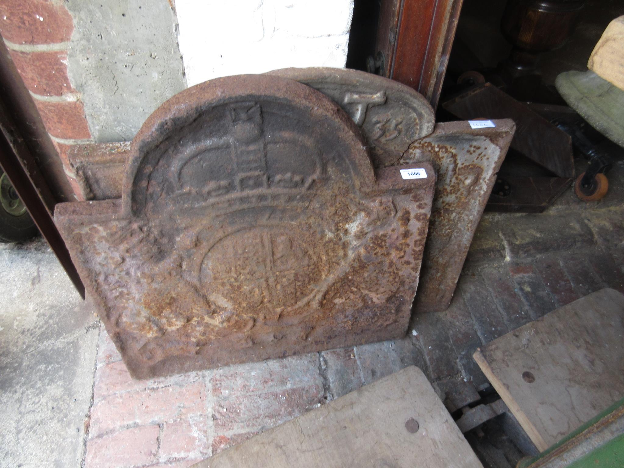 Two antique cast iron fire backs bearing coats of arms (one cracked)