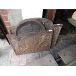 Two antique cast iron fire backs bearing coats of arms (one cracked)