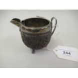Native figural carved nut mounted in white metal as a jug, 3ins high