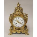 19th Century French ormolu mantel clock of rococo design, the enamel dial with Arabic and Roman