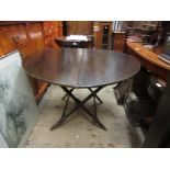 Late 19th / early 20th Century circular oak folding coaching table on turned supports, labelled