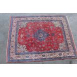 Modern Sarouk carpet of all-over floral design on a red and cream ground with borders, 3.15m x 2.44m