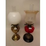 Late 19th / early 20th Century brass and ceramic oil lamp having red glass well and later etched