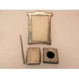 Silver cigarette case, watch case, photograph frame and a comb mount