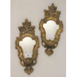 Pair of Italian carved giltwood wall mirrors with floral decoration, 16ins high and a cream