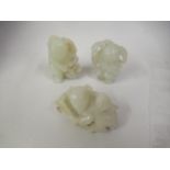 Three miniature Chinese carved pale jade figures, the tallest approximately 1.75ins Some chips and