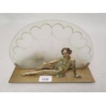 Art Deco painted metal table lamp in the form of a seated girl before an opaque glass fan shaped