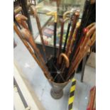 Toleware stick stand in the form of an umbrella containing a quantity of various walking sticks